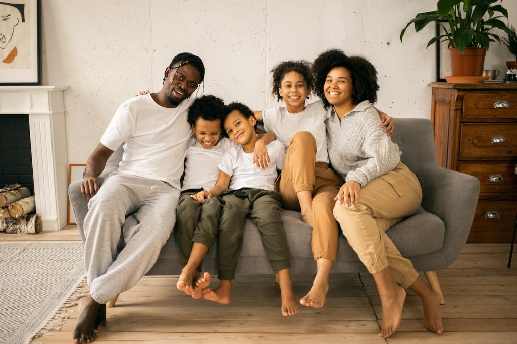 Family cuddling on couch